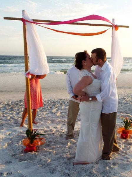 This couple exchanged vows under a 2 post arbor, decorated with tulle.